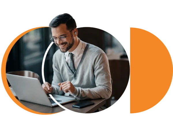 corporate professional smiling infront of laptop