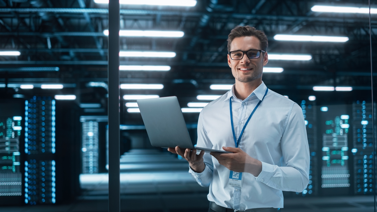 A working corporate professional standing with laptop