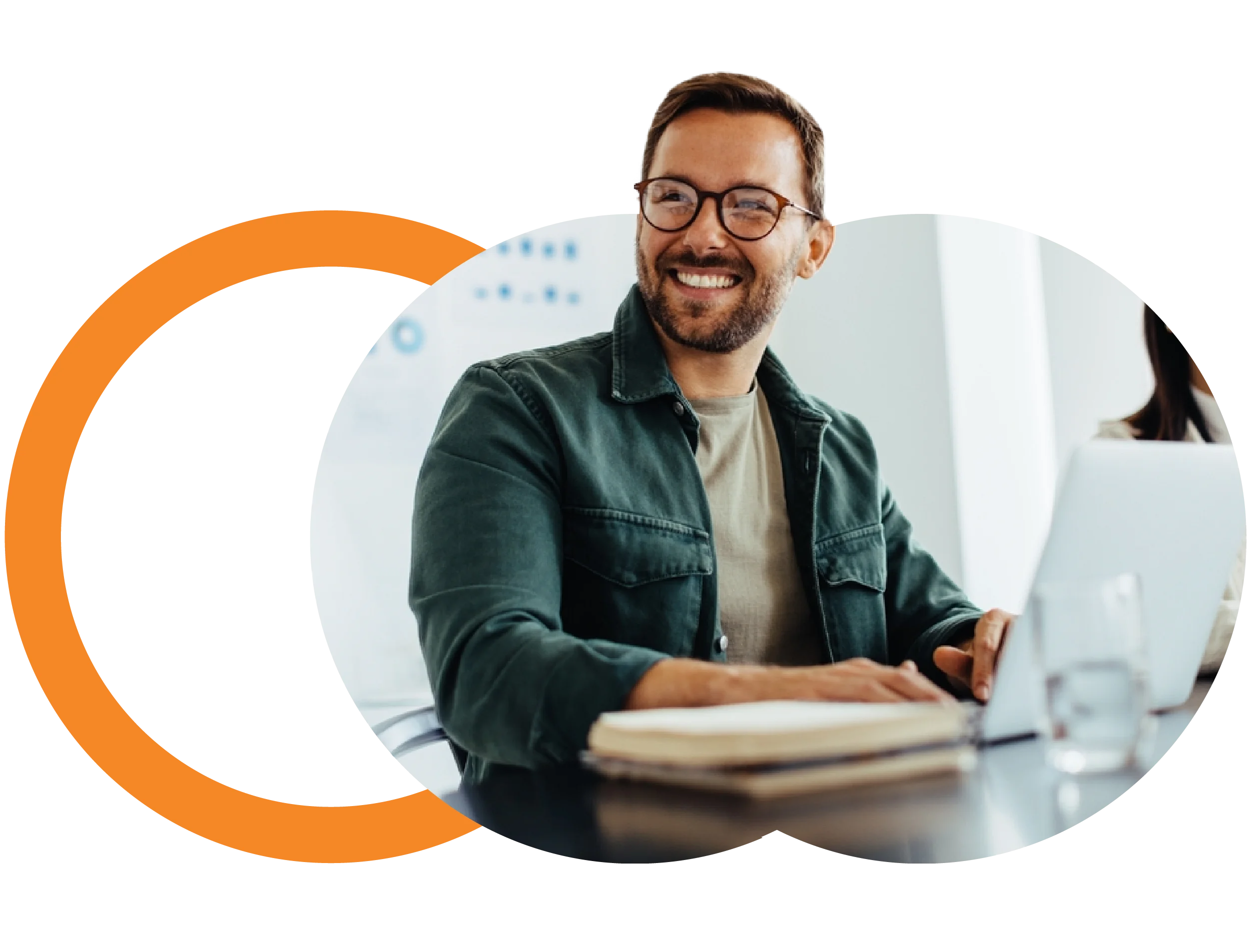 Man smiling infront of a laptop